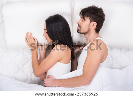 Young couple is sleeping on the mattress. Top view.