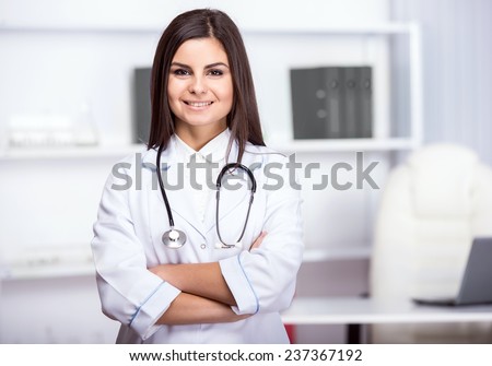 Smiling, beautiful medical doctor woman in medical room.