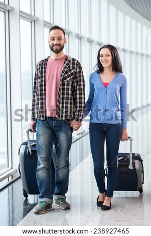 Young couple with luggage bags at airport are ready to flight.