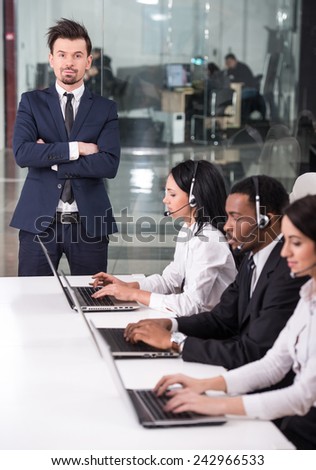 Manager is explaining something to employees in a call centre
