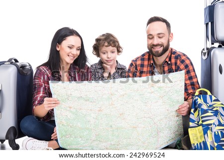 Happy family with luggage and map are ready to travel. Isolated on white background.