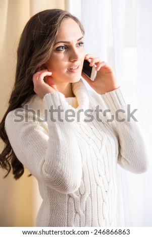 Side view of beautiful woman is talking on phone.