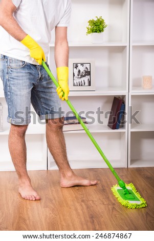 Young man is doing some cleaning work in the house.