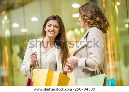 Two happy friends with shopping bag is shopping in mall.