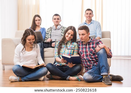Education and people concept. Group of students with books are studing all together.