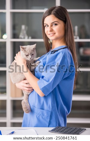 Portrait of a young female doctor with a cute beautiful cat.
