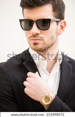Portrait of young trendy man with black glasses.