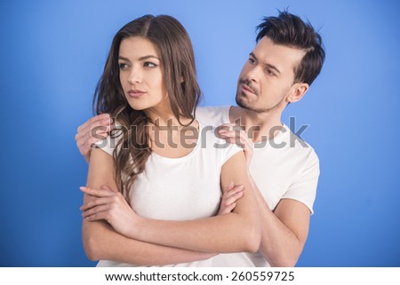 Close-up portrait of stressed people are going through hard times in relationship, isolated on blue background .