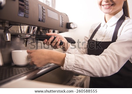 Smiling female barista is preparing espresso at coffee shop.