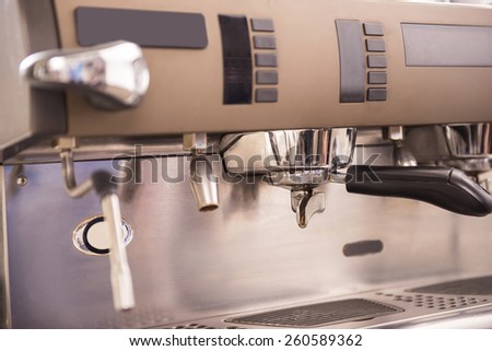 Barista prepares espresso in his coffee shop. Close-up