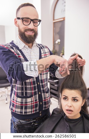 Female client in hairdressing salon scared about cutting.