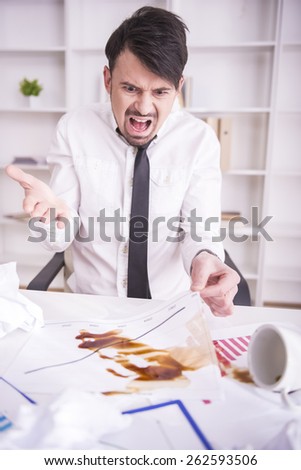 Businessman angry over spilled coffee on documents