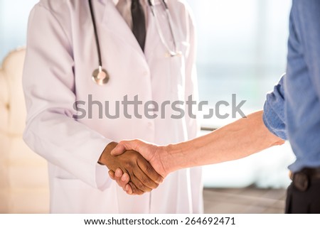 Close-up. Medical concept. The doctor and patient shaking hands.