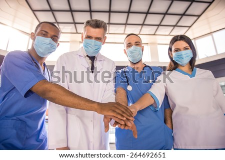 Group of doctors in mask. Teamwork.  In hospital.