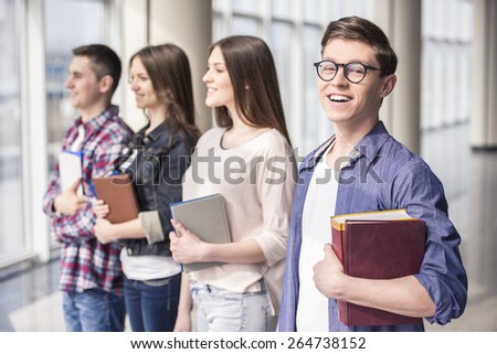 Group of happy young students in a college.