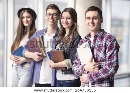 Group of happy young students in a university.