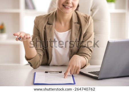 Close-up. Businesswoman hand holding resume on desk.