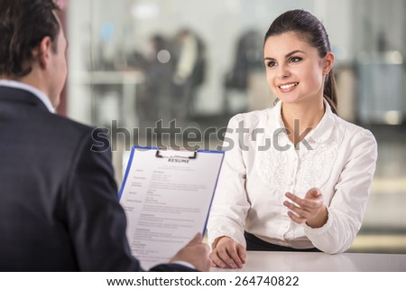 Businessman interviewing female candidate for job in office.