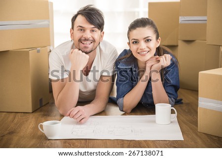 The young happy couple planning a new house. Moving, purchase of new habitation.
