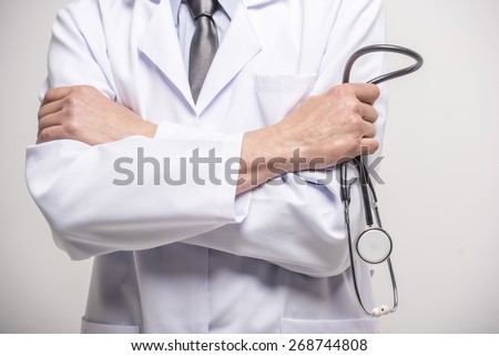 Close-up. Doctor hands crossed with stethoscope.