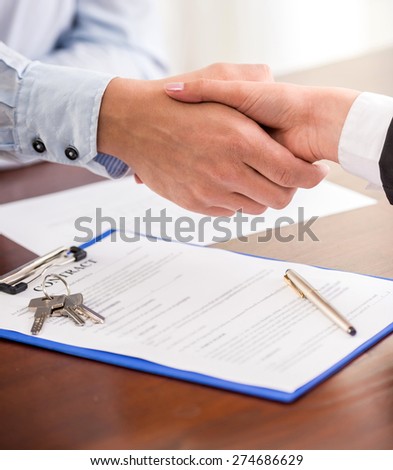 Handshake of a real estate agent and a client.