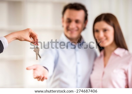 Man with his wife being given a house key.