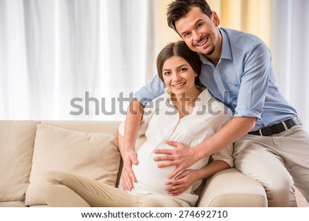 Happy family lifestyle. Portrait of  young couple are expecting a baby.