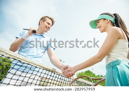 Couple handshaking at the tennis court after a match.