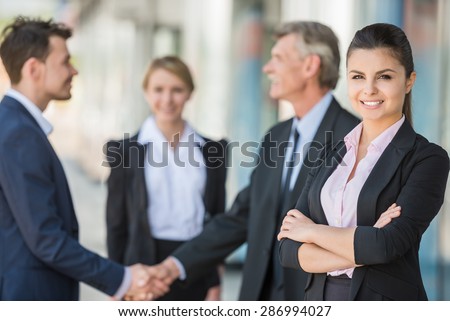 Meeting of business people. Two confident business men shaking hands.