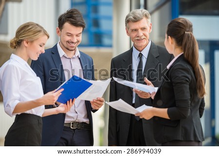 Group of successful business people in suits on business meeting. Office background.
