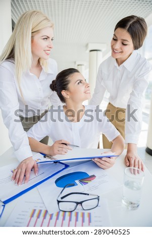 Female business team dressed formal sitting at office center and brainstorming.