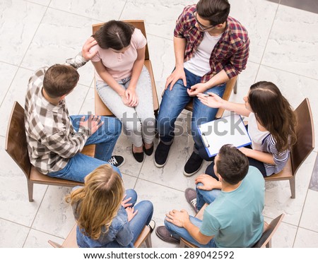 Group therapy. Group of people sitting close to each other and communicating.