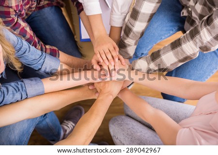 Circle of trust. Group of people sitting in circle and supporting each other.