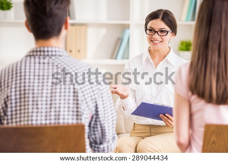 Psychologist helping to young couple in her private consulting room.
