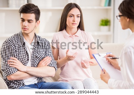 Psychologist helping to young couple in her private consulting room.