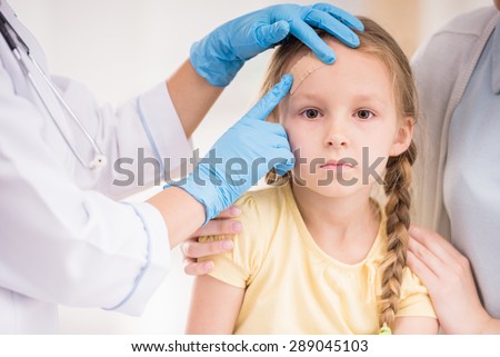 Pediatrician doctor getting plaster to child\'s wound. Close-up.