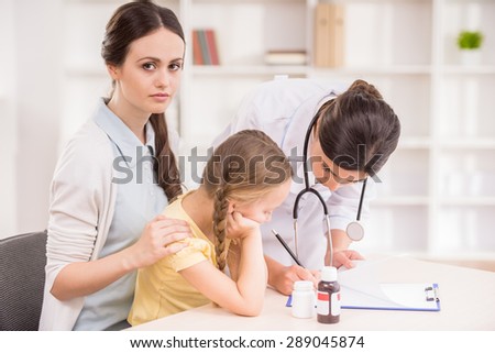 Mother and her little daughter visiting doctor\'s office.