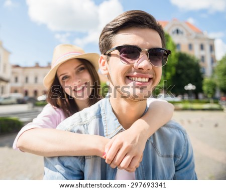 Beautiful young couple riding scooter. Fun time together.
