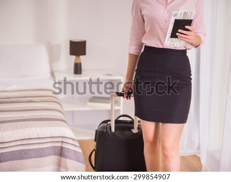 Business woman with her documents and suitcase at the hotel room. Close-up.