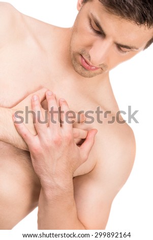 Strong shirtless man with heart pain isolated on white background.