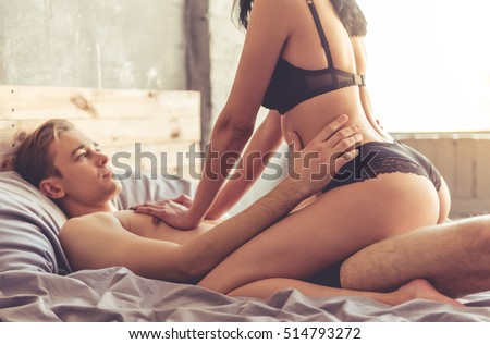 Sensual beautiful young couple is having sex on bed