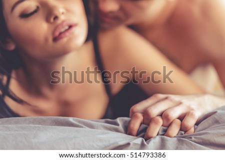 Sensual beautiful young couple is having sex on bed
