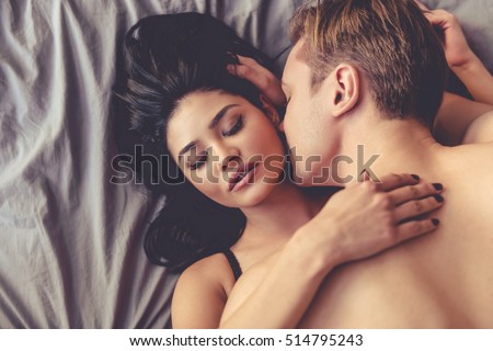 Top view of sensual beautiful young couple having sex on bed