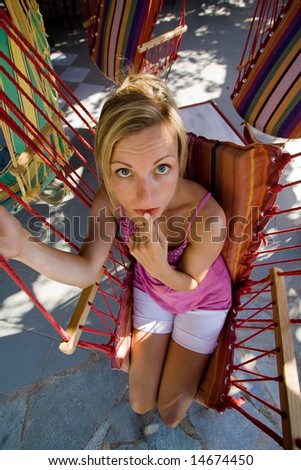 Innocent looking girl in a hammock chair