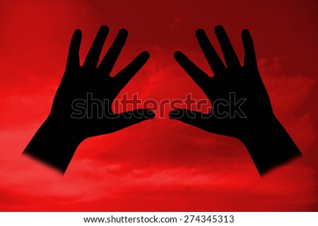 The black palm hand on red dark background