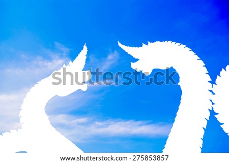 The naga white silhouette on blue sky cloud background