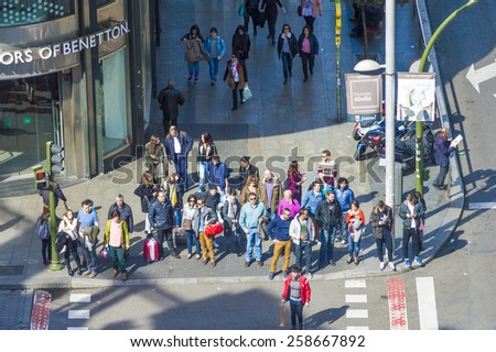 Madrid, Spain.  March 1, 2015. A group of people are waiting for to be able to cross the street in \