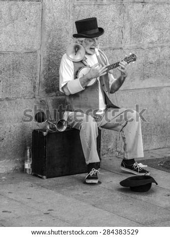 Madrid - May 31, 2015: One-man band acts for the tourists in the major square of Madrid