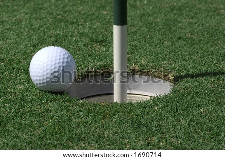 Golf ball about to go in hole, space on ball for logo