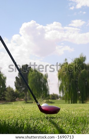 close-up of driver and golf ball on tee ready to tee off at golf course